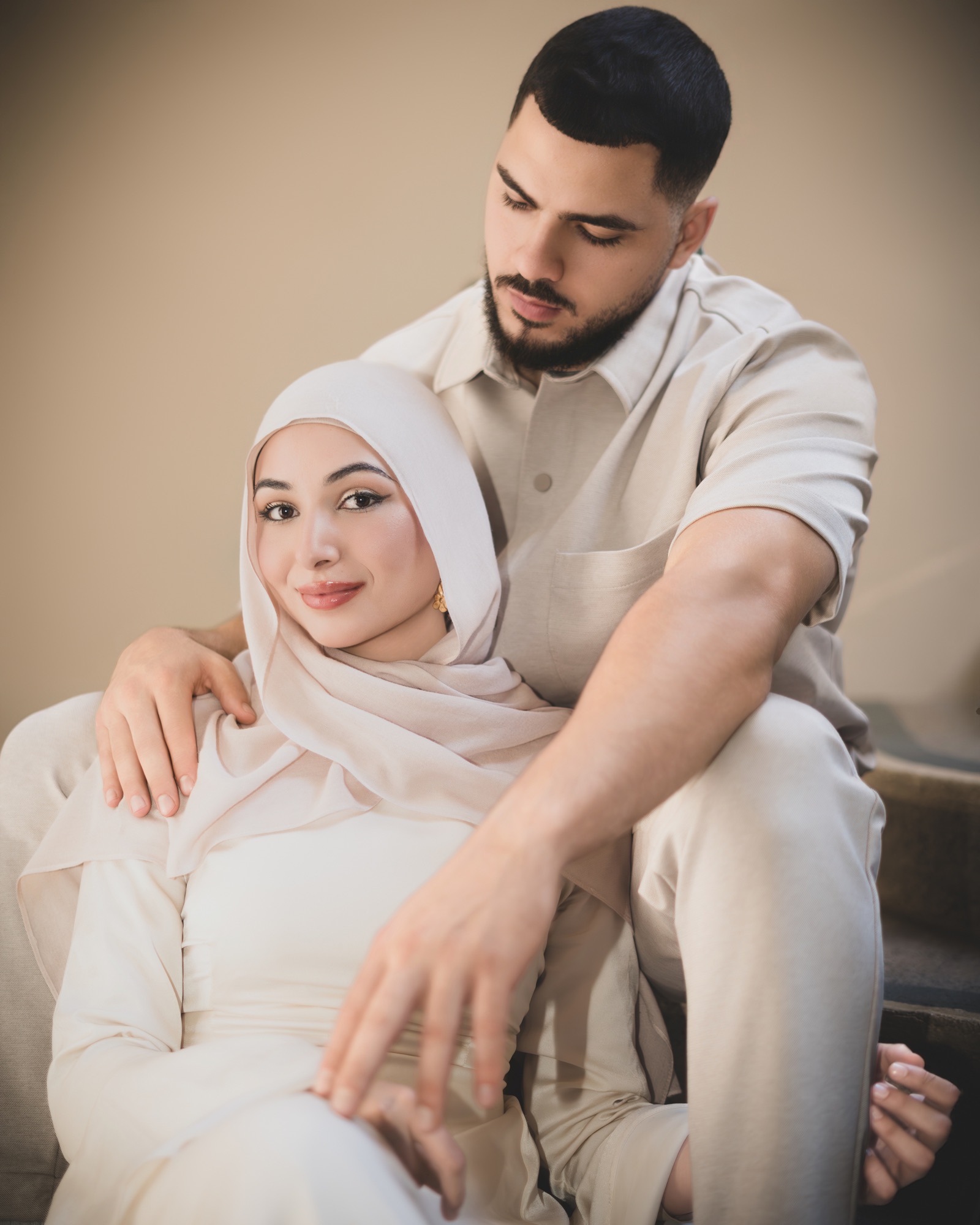 Couple embracing in a softly lit studio portrait