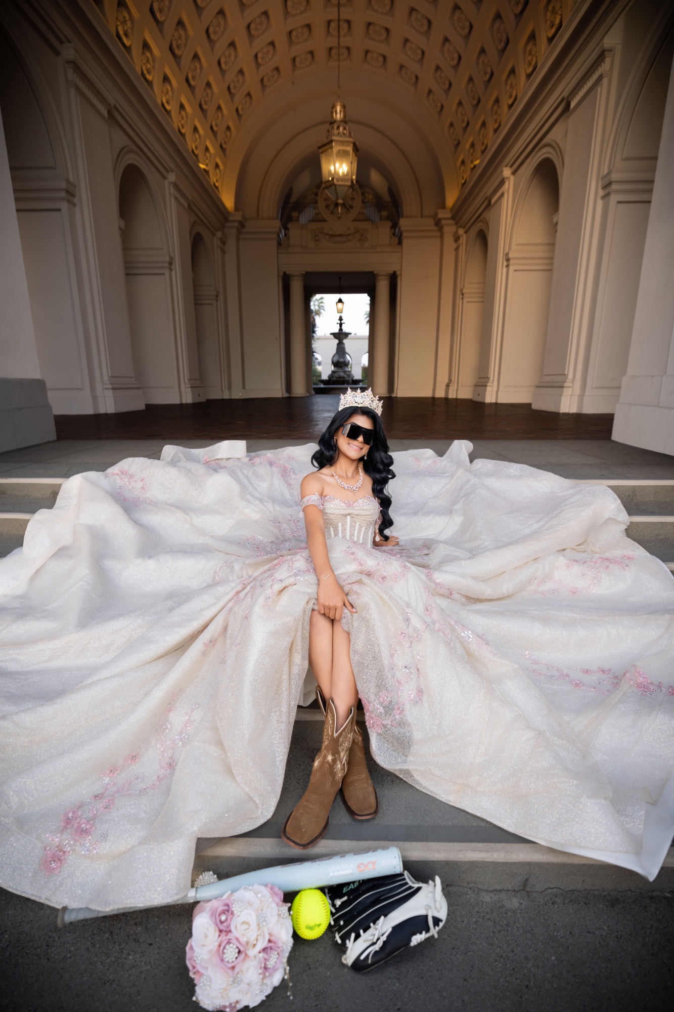 Quinceañera with sunglasses, boots, and softball equipment